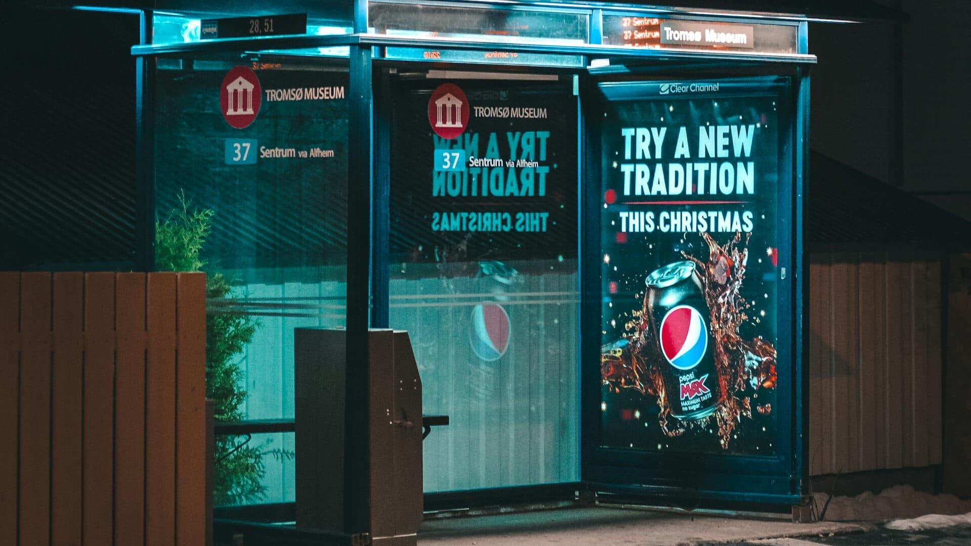 Bus stop advertising panel on a busy UK high street