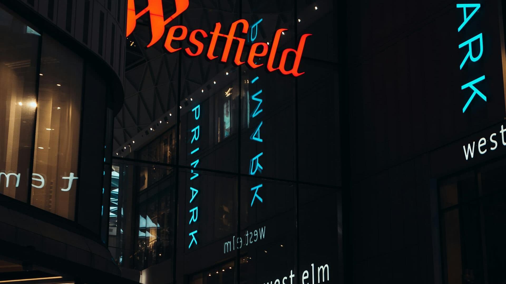 Digital advertising screen inside a busy UK shopping centre