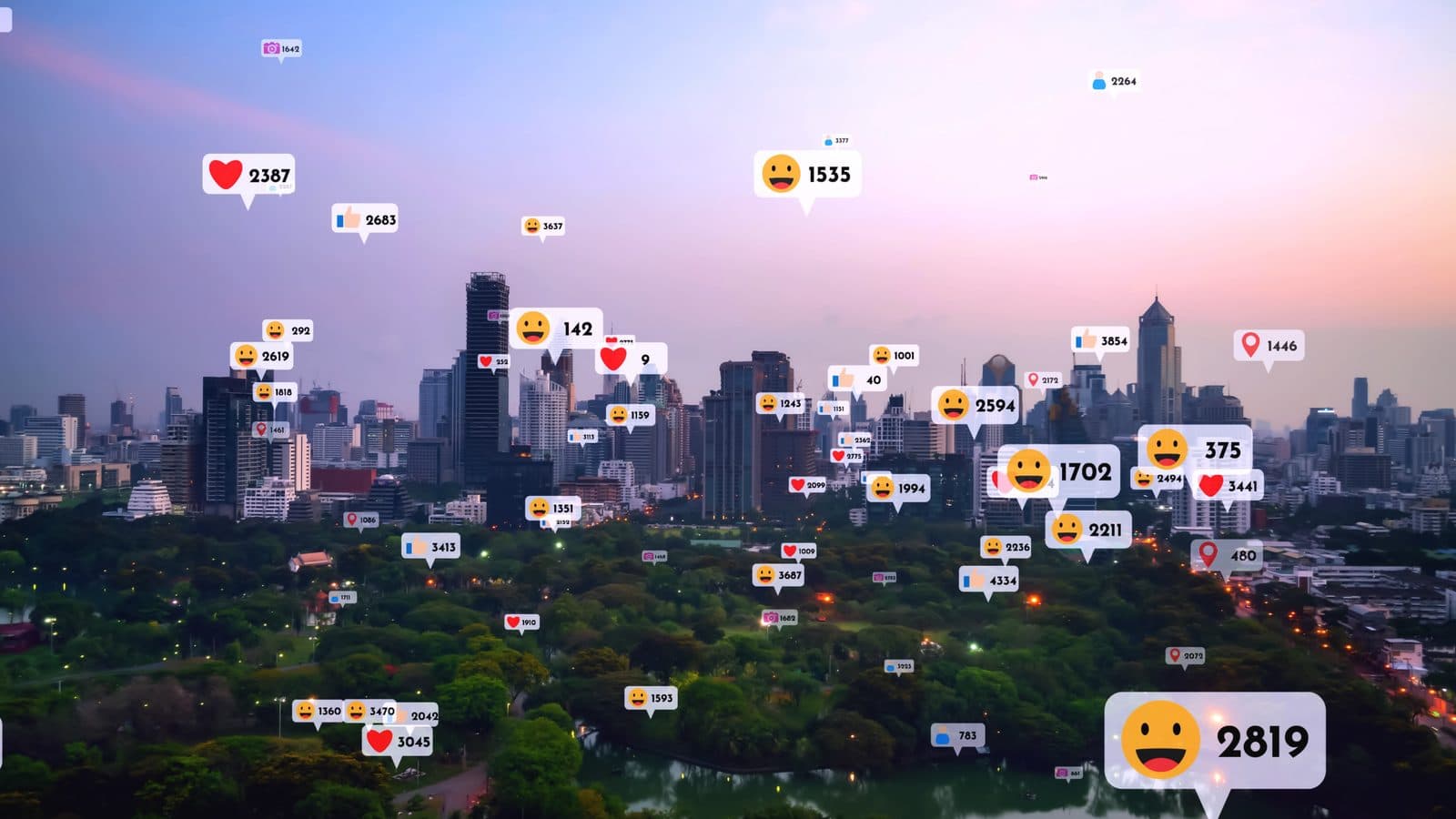 A city skyline at dusk with floating like, heart and emoji counters rising above the buildings