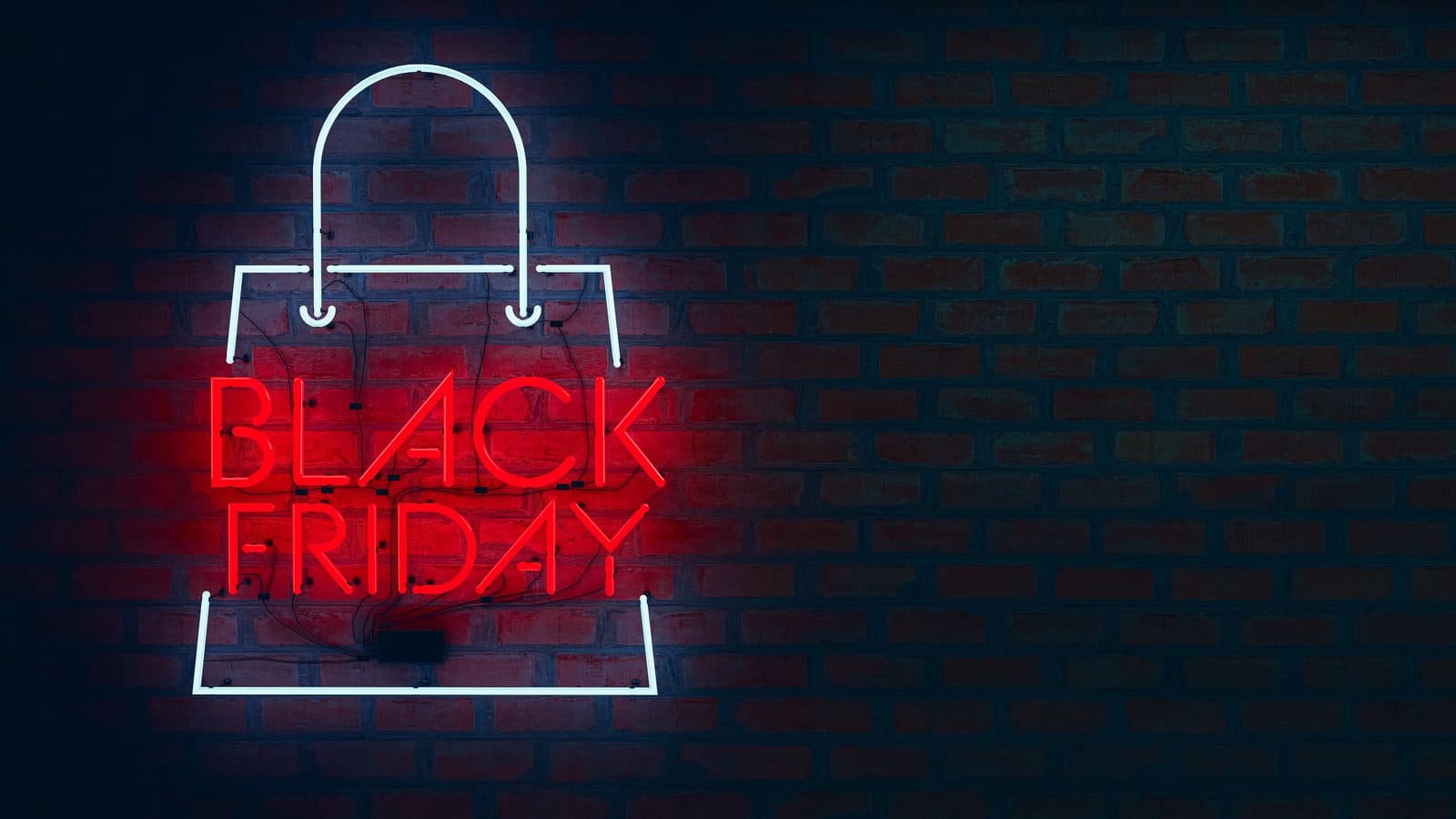 A neon shopping bag sign with Black Friday in glowing red letters on a dark brick wall