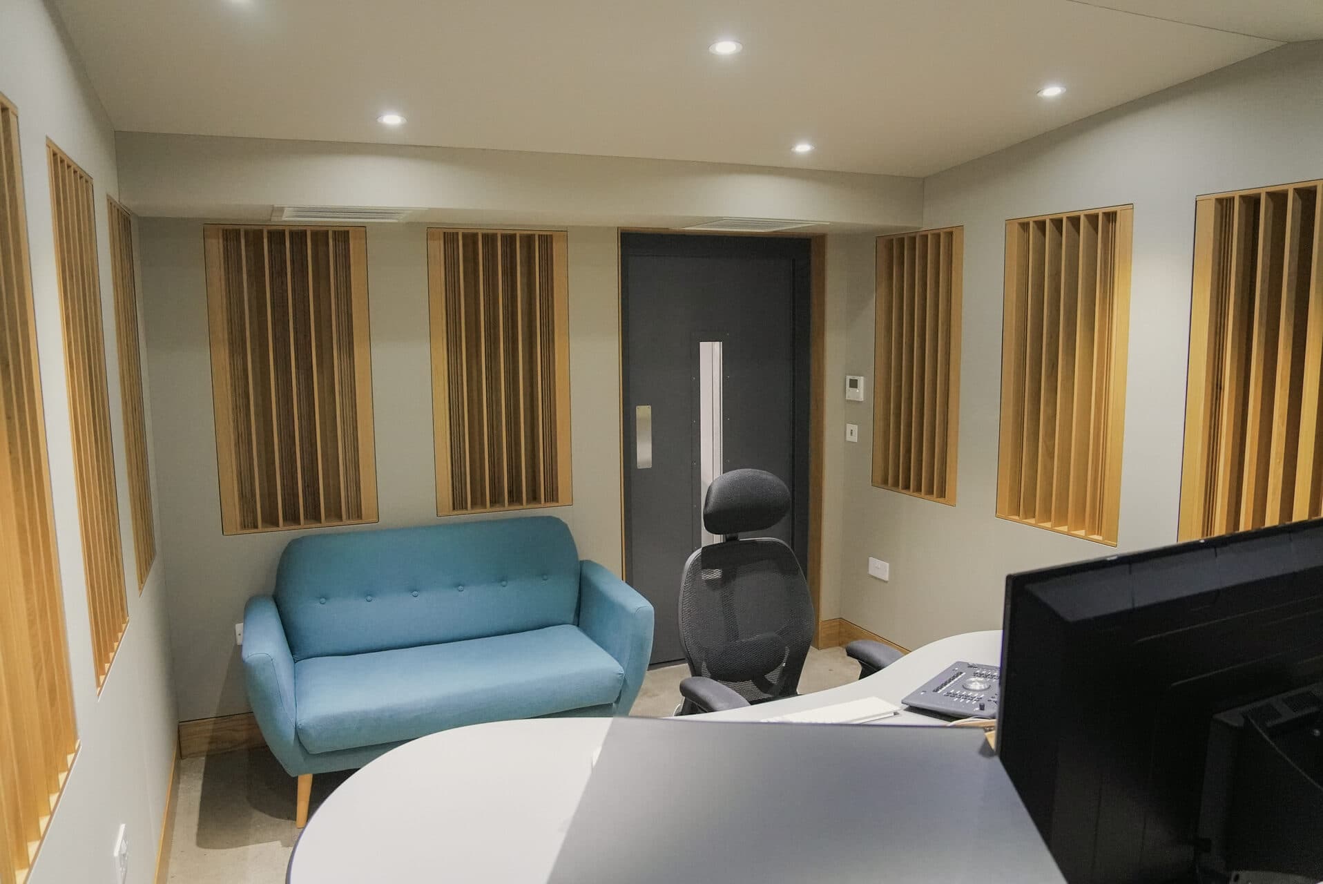 Studio lounge area with acoustic panels and comfortable seating